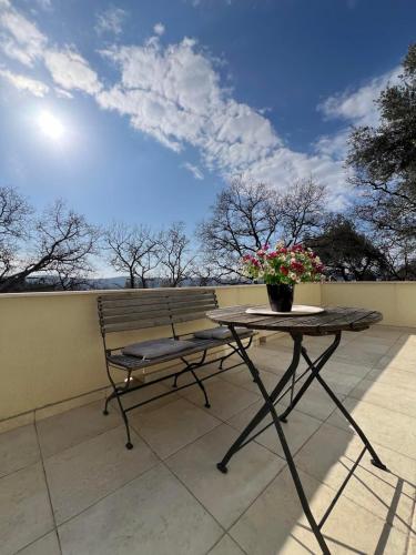 a bench and a table on a patio at Casa del Sole Lux in Kotor