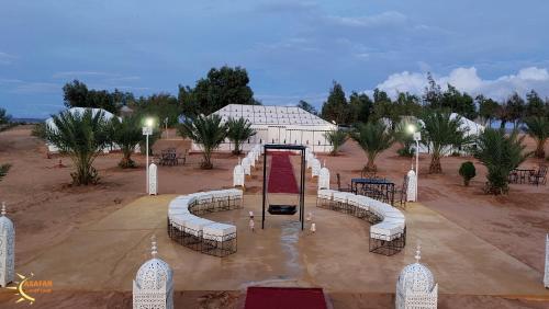 a wedding set up with chairs and tables in front of a building at Asafar Luxury Camp in Merdani