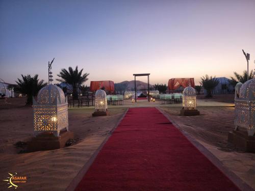 a red carpeted walkway with lights on it at Asafar Luxury Camp in Merdani