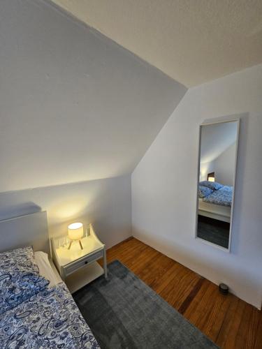 a bedroom with a bed and a mirror at BothsAnleger in Kasseedorf