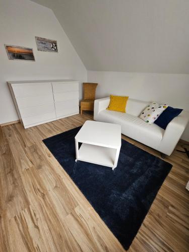 a living room with a white couch and a table at BothsAnleger in Kasseedorf