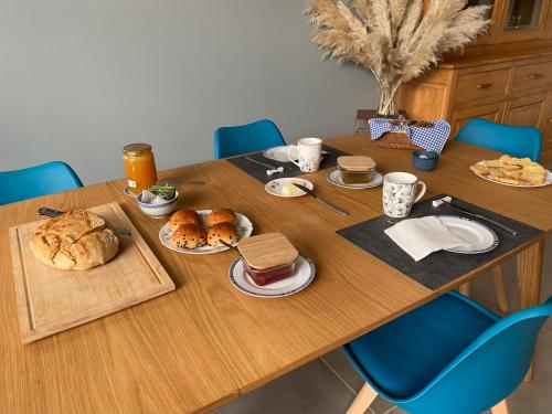 a wooden table with food on top of it at chez Odette Cypres de Provence in Esnoms-au-Val