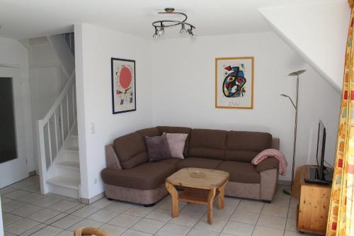 a living room with a couch and a table at Ferienwohnung Sünnenkringel 58 in Zingst