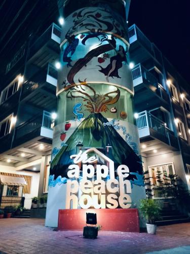a sign for an appleokedoked house in front of a building at The ApplePeach House in Legazpi