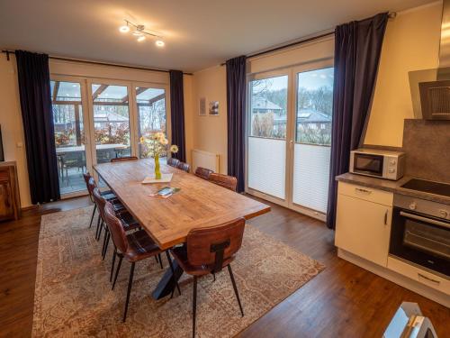 a dining room with a wooden table and chairs at Terra am Plauer See m Garten in Malchow