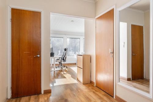 an empty room with a hallway with a desk and a chair at Ihana omakotitalo omalla pihalla in Turku
