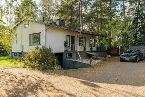 a house with a car parked in front of it at Ihana omakotitalo omalla pihalla in Turku