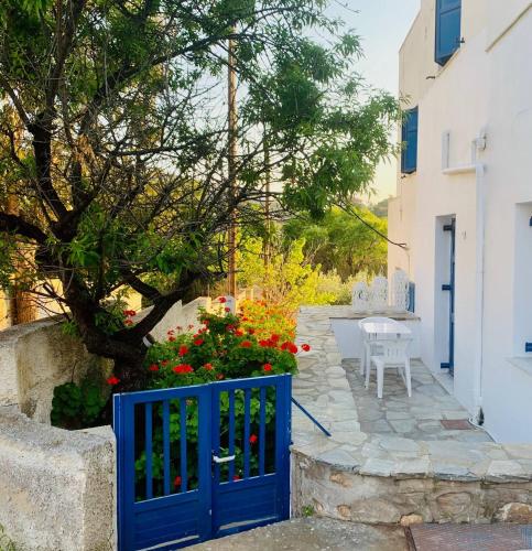 a blue gate in a garden with flowers at Love Limni No 1 in Peaceful Poseidonia in Posidhonía