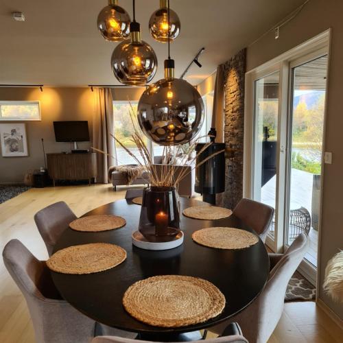 a dining room with a black table and chairs at Sand Beachhouse in Sand