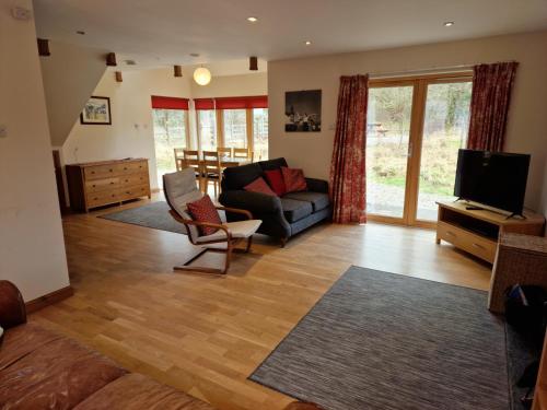 a living room with a couch and a television at Shepherds Rest in Fort William