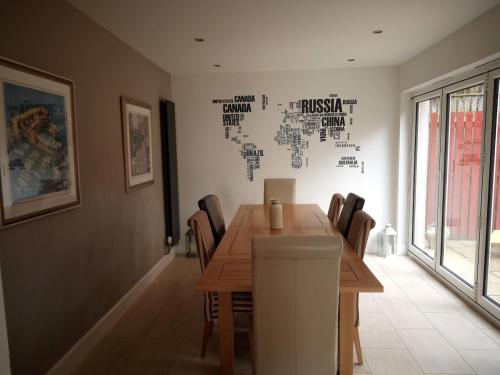 a dining room with a wooden table and chairs at Burntisland Near Edinburgh with Hot Tub in Burntisland