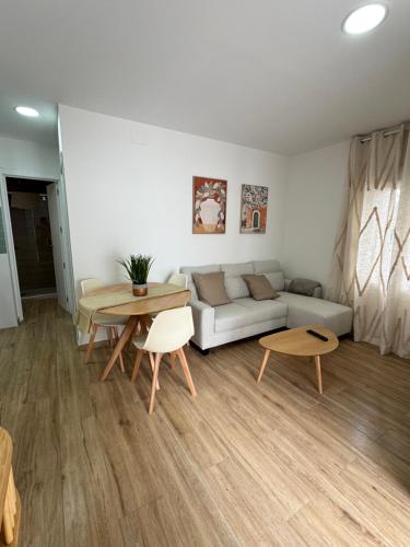 a living room with a couch and a table at La casita de fuente grande in Alfacar