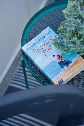 a book sitting on top of a chair at Apartman Nives in Kremena