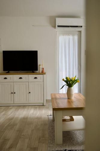 a living room with a television and a table at Apartman Nives in Kremena