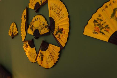 a group of yellow paper umbrellas on a wall at The Imperial Dragon Hotel in Saundersfoot