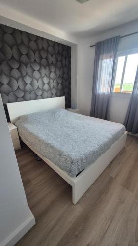 a bedroom with a large bed in a room at CASARES appart 2 ch dans parc tropical avec vue sur mer, montagne et piscine in Casares