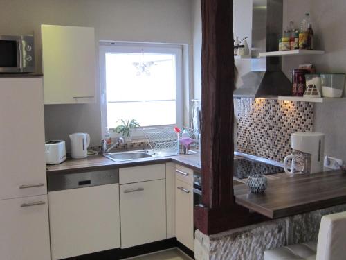 a kitchen with a sink and a window at Feha ehemaliger Stall in Langelsheim