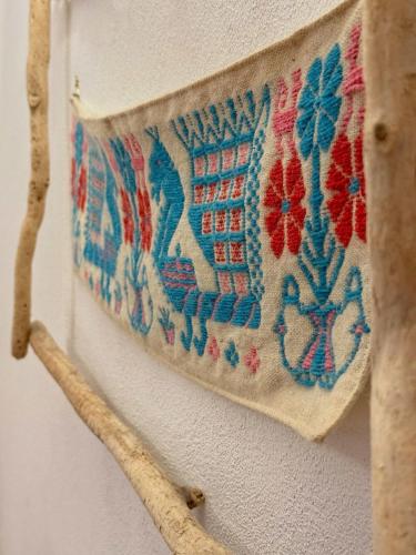 a tapestry hanging on a wall next to a building at Regnos Altos boutique rooms in Bosa