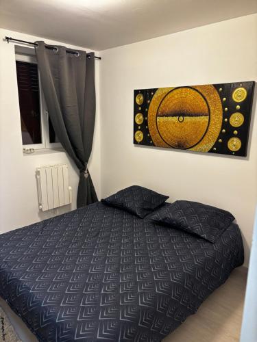 une chambre avec un lit et un tableau au mur dans l'établissement Charmant appartement 2 chambres, à Givors