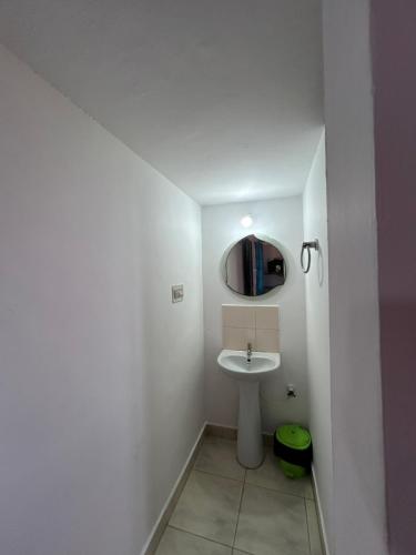 a small bathroom with a sink and a mirror at Mountain View Villas in Madikeri