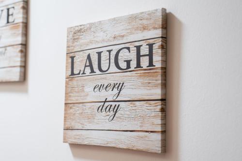 a sign that reads laugh every day on a wall at Prime location rooms in high street in Fort William