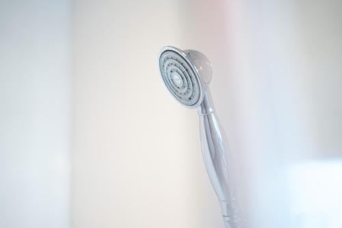 a shower in a bathroom with a shower head at Prime location rooms in high street in Fort William