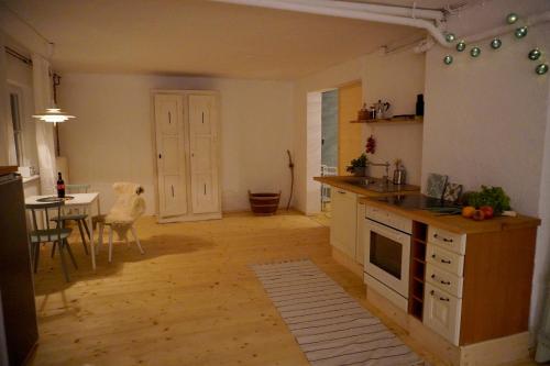 a kitchen with a dog sitting in the middle of it at Oide Schreinerei in Steingaden