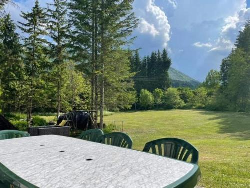 a table and chairs in a field with a view at Ferienhaus Roman in Farnau