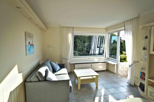 a living room with a couch and a table at Hanseat II Whg 145 in Grömitz