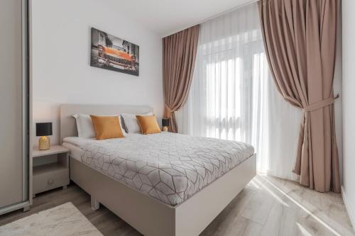 a bedroom with a bed and a large window at Cream Divine in Oradea
