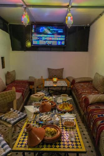 a living room with a table with food on it at Dar Amazigh in Fès