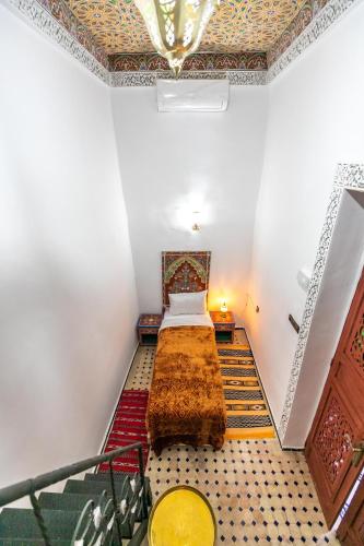 a room with a bed in the middle of a room at Dar Amazigh in Fès