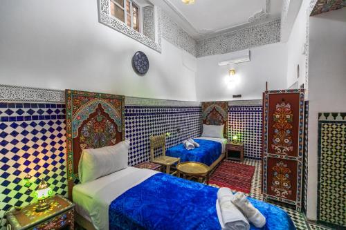 Postel nebo postele na pokoji v ubytování Dar Amazigh