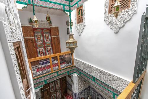 an overhead view of a stairway in a building with colorful tiles at Dar Amazigh in Fès