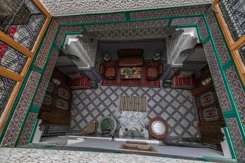 an ornate bathroom with a sink and a mirror at Dar Amazigh in Fès