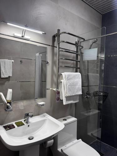 a bathroom with a sink and a toilet and a shower at Salomat guest house in Samarkand