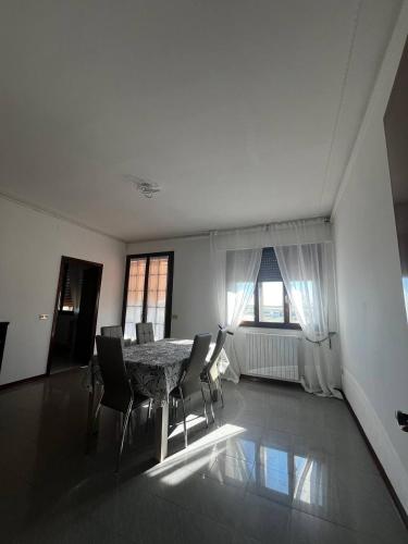 a large room with a table and chairs in it at Garden Country House in Fogolana