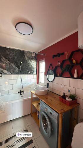 a bathroom with a washing machine and a sink at Дом в горах Уютный дом с потрясающим видом и огромной террасой in Besqaynar