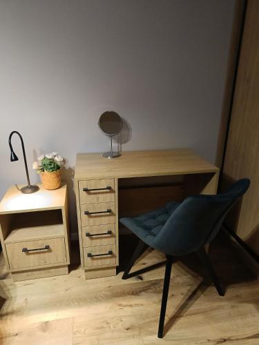 a desk with a chair and a desk with a lamp at MODERN APARTAMENT Walendów in Walendów