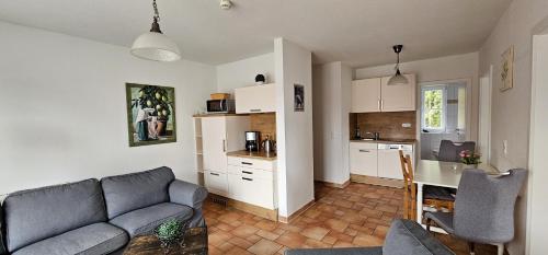 a living room with a couch and a kitchen at Seeadler I in Dierhagen