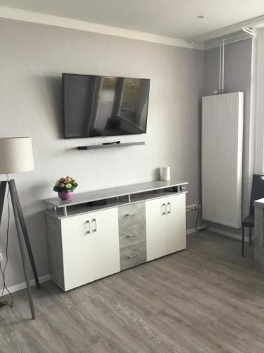 a living room with a tv on the wall at Hafenwohnung in Borgwedel