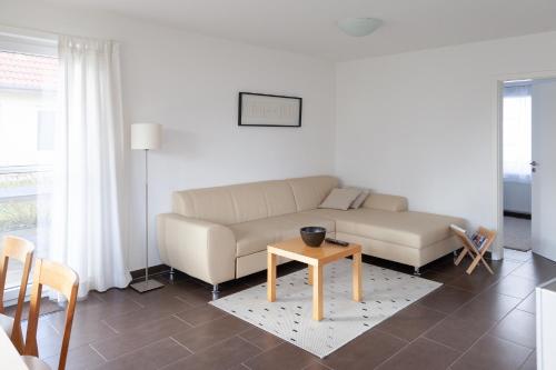 a living room with a couch and a table at Ferienhaus Innenförde in Holnishof