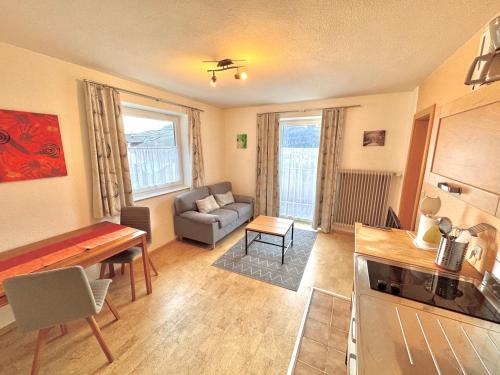 a living room with a couch and a table at Haus Greif in Weissenbach am Lech