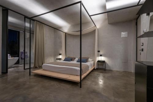 a bedroom with a bed with a glass canopy at Casa Plenilia in Pianella