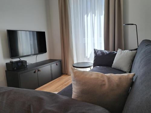 a living room with a couch and a flat screen tv at Eck am Meer 2 in Eckernförde
