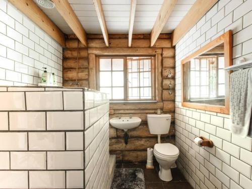 a bathroom with a toilet and a sink at Stone cottage in Haarties in Kalkheuvel