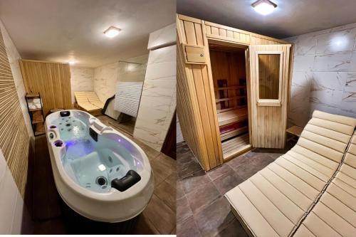 a bathroom with a bath tub in the middle of a room at Guest House Andrea in Rogachevo
