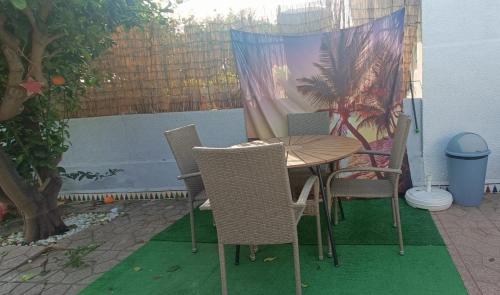 a wooden table and chairs on a patio at Muy bien in San Javier