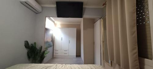 a bedroom with a bed and a hallway with a door at Muy bien in San Javier