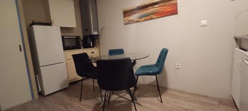 a kitchen with a table and chairs and a refrigerator at Muy bien in San Javier